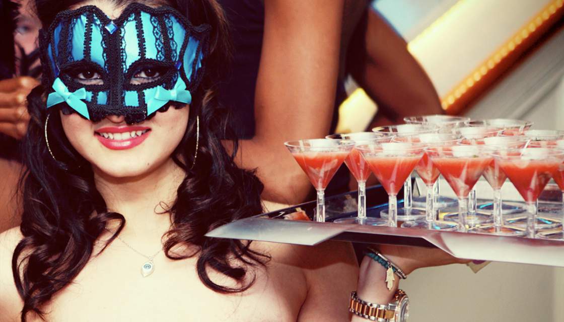 Penthouse girl carrying tray of martinis and wearing a lacy mask picture